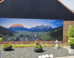 Gartenposter Picturesque mountain village situated in a lush valley surrounded by verdant hills, Lermoos, Tirol